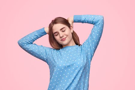 Teen girl stretching after sleepの写真素材