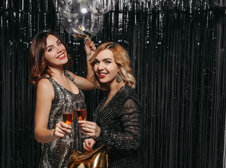 Female friends drinking champagne at Christmas night party