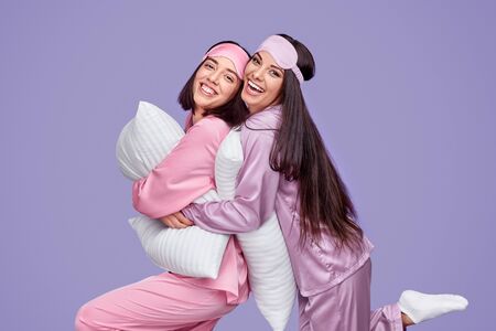 Delighted best friends hugging during slumber partyの写真素材