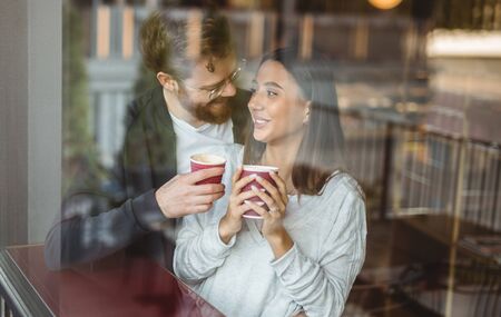 Happy couple enjoying coffee during dateの写真素材