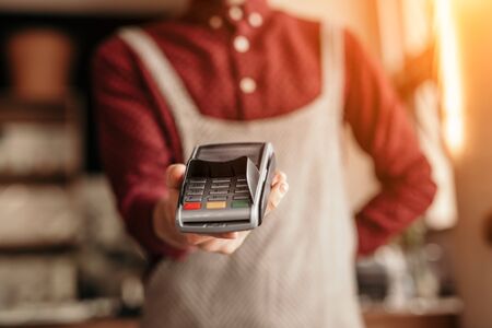 Crop waiter offering payment terminalの写真素材