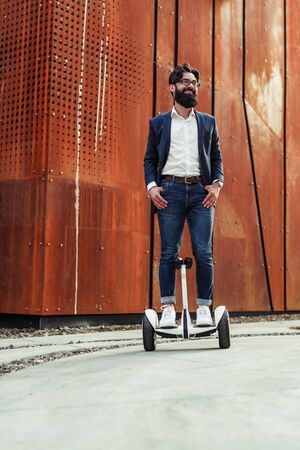 Positive guy riding eco vehicleの写真素材