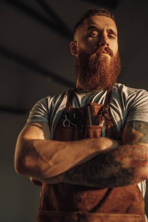 Serious male stylist looking at cameraの写真素材