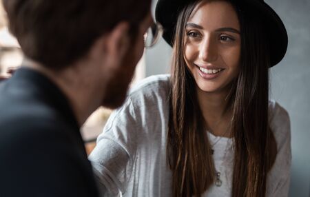 Delighted lady communicating with boyfriend in restaurant