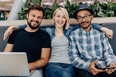 Happy young woman with diverse colleaguesの写真素材