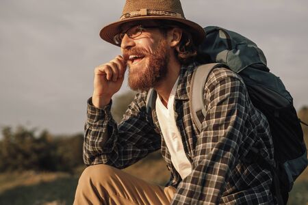 Cheerful bearded traveler in nature