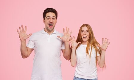 Excited couple showing ten with hands