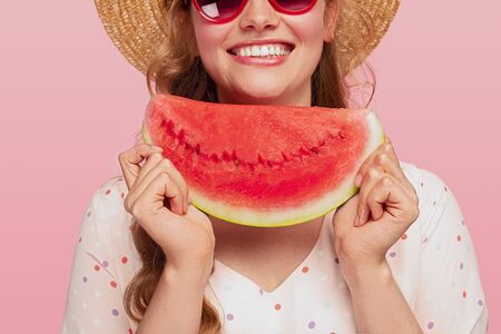 Crop cheerful young lady with watermelonの写真素材