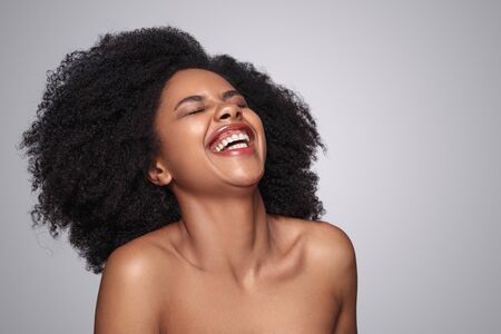 Beautiful black woman with clean skin laughingの写真素材