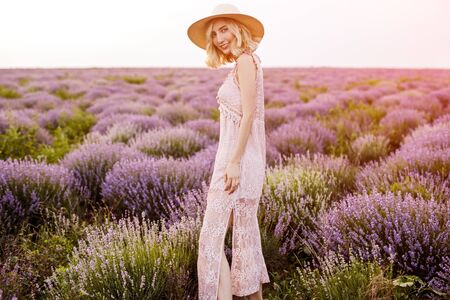 Cheerful elegant female in lavender fieldの写真素材