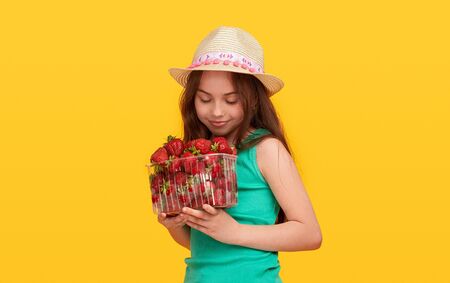 Teenager enjoying smell of strawberriesの写真素材