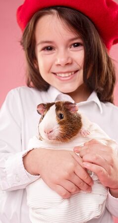 Happy girl hugging guinea pigの写真素材