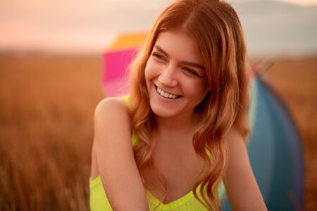 Happy young woman resting in summer meadowの写真素材