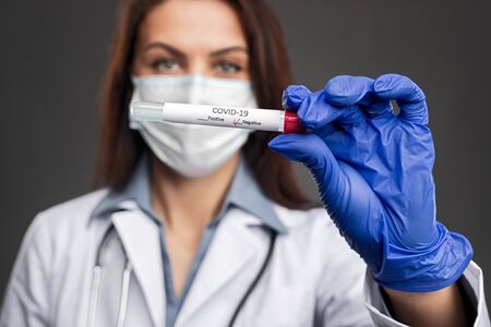 Doctor showing tube with negative coronavirus test