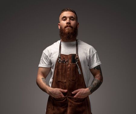 earded barber looking at cameraの写真素材