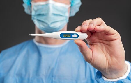 Doctor showing thermometer with normal temperature