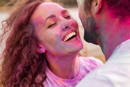 Young woman having fun with boyfriend during festivalの写真素材