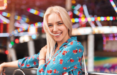 Cheerful young woman in amusement park