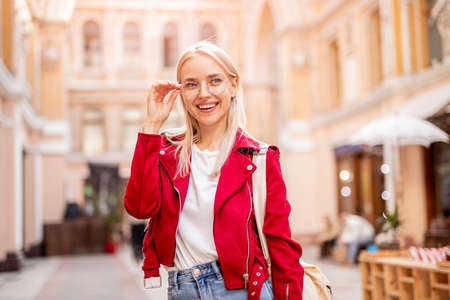 Stylish woman standing on city streetの写真素材