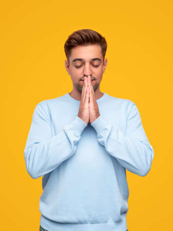 Young man praying to Godの写真素材