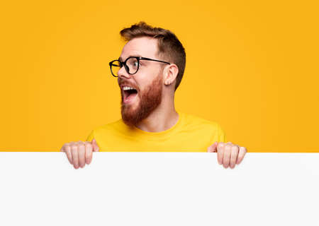Excited bearded man with empty bannerの写真素材