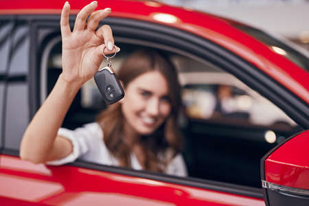 Woman showing keys of new carの写真素材