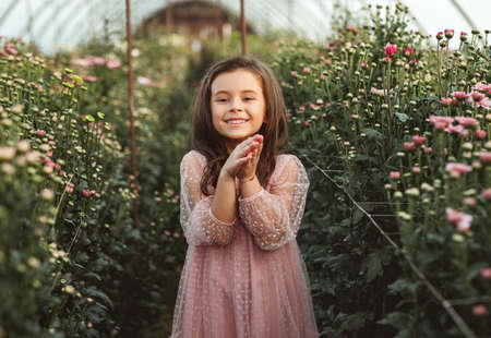 Happy little girl in greenhouseの写真素材