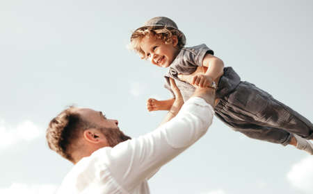 Happy father tossing little son