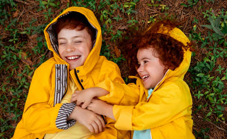Happy ginger kids playing on forest groundの写真素材