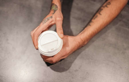 Anonymous barista serving takeaway coffeeの写真素材