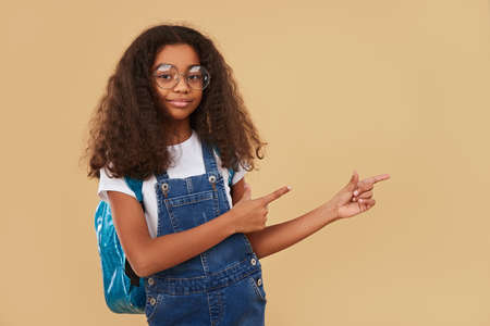 African American schoolgirl pointing away