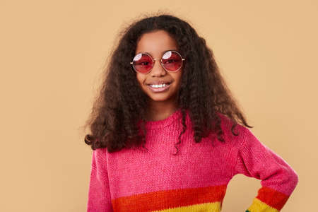 Positive African American girl in rainbow sweaterの写真素材