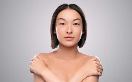 Ethnic female model touching shoulders