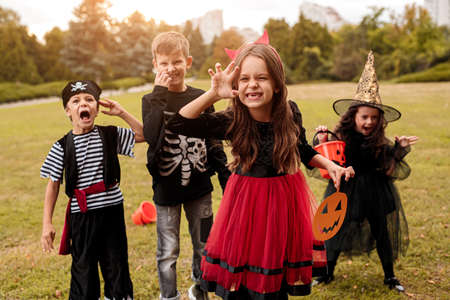 Little devil celebrating Halloween with friends
