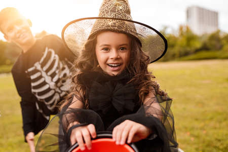 Girl in halloween costume asking for candies