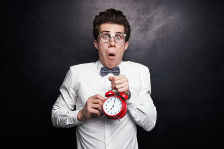Shocked nerd with alarm clock