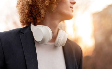 Crop man with wireless headphones