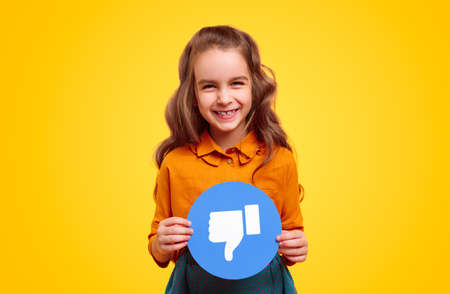 Cheerful girl with dislike symbolの写真素材