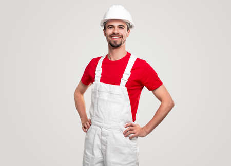 Positive male contractor with hands on waistの写真素材