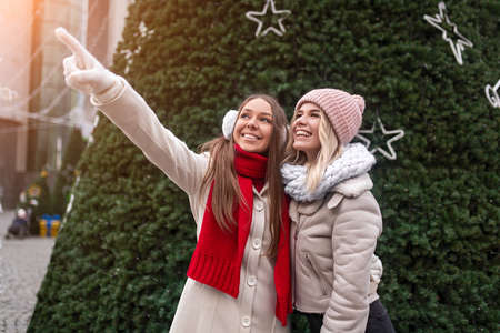 Happy young women near Christmas treeの写真素材