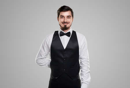 Confident smiling waiter in elegant outfit