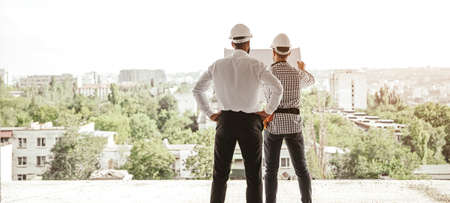 Architects discussing construction plan in city