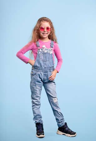 Fashionable girl in denim overallの写真素材