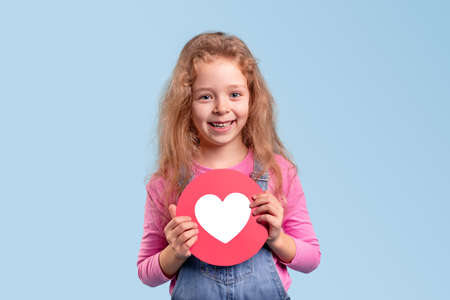 Happy girl with red heart sign
