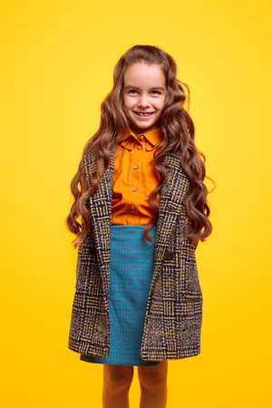 Cheerful schoolgirl in warm coatの写真素材