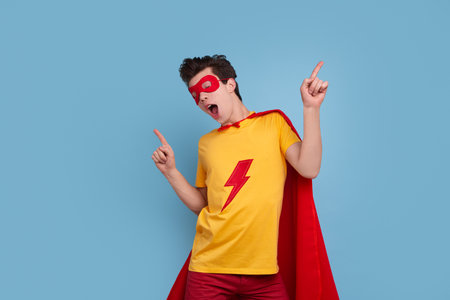Funny man in superhero costume dancingの写真素材