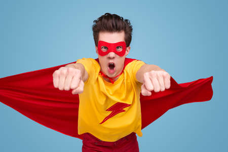 Brave superhero flying towards cameraの写真素材