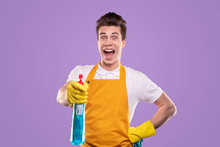 Happy man with detergent looking at cameraの写真素材