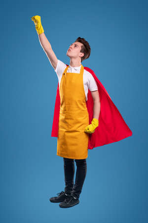 Superhero man in apron and glovesの写真素材
