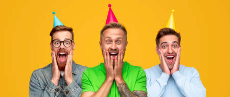Excited shocked men in party hats